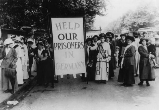 A crowd of female protestors in Britain, bearing a placard which reads \'Help Our Prisoners in Germany\', circa 1914. They are protesting the internment of thousands of British civilians at Ruhleben (now a district of Berlin) at the start of World War I. (Photo by Central Press/Hulton Archive/Getty Images)
