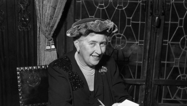 circa 1965: British mystery author Agatha Christie (1890-1976) autographing French editions of her books.