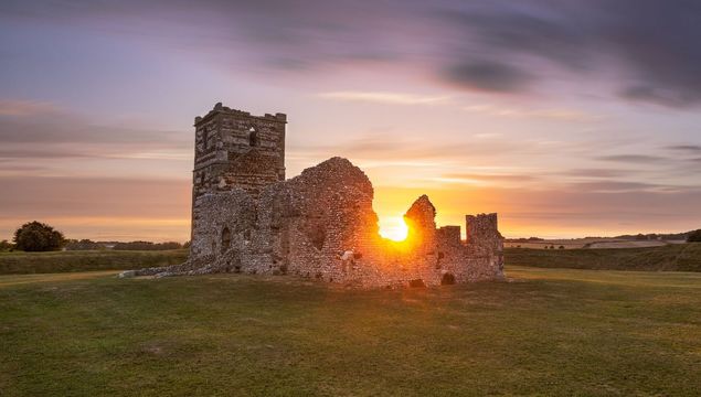 Sun setting on Knowlton Church, in Cranborne.