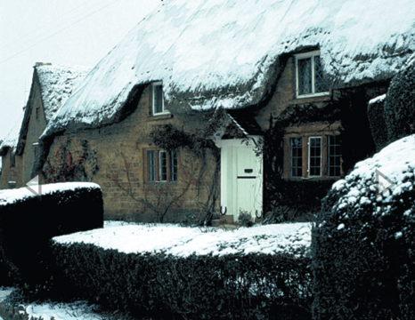 Snow decorates a thatched cottage in Great Tew.[