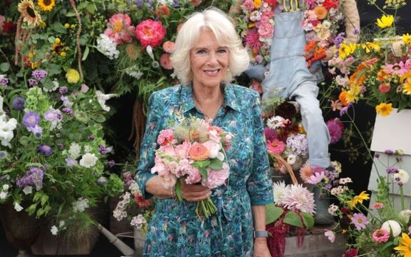 Camilla, Queen of England smiles during a visit to The Sandringham Flower Show 2022