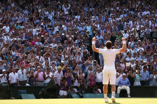  Fans cheer and take photographs as Andy Murray of Great Britain celebrates victory in the Gentlemen\'s Singles Final match against Novak Djokovic of Serbia