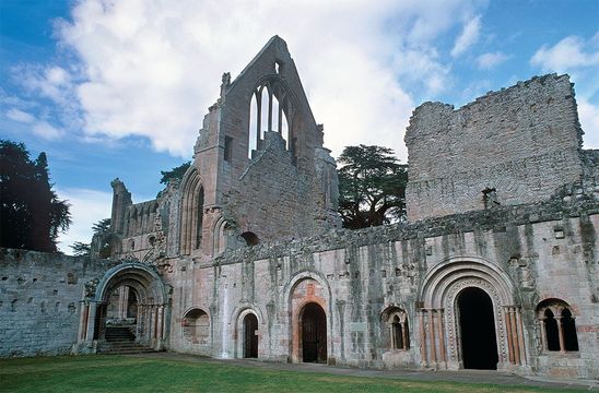 In the prettiest setting of the four great Border abbeys, Dryburgh Abbey is still a place of pilgrimage—to the final resting place of Sir Walter Scott.