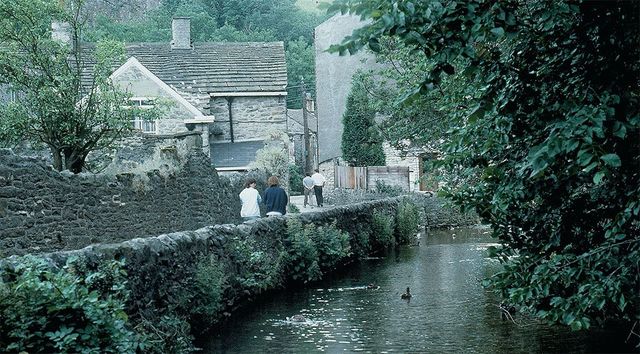 Visitors stroll down the pretty riverside walk from the Peak Cavern to the village of Castleton, nicknamed “Gem of the Peaks.”