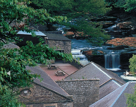 Cascading water from the pretty River Clyde provided power to the 18th-century mills of New Lanark.