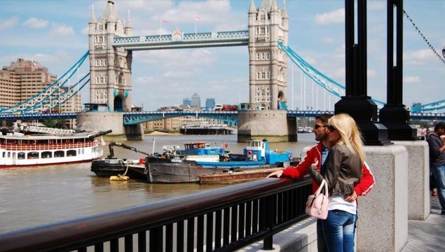 Tourists enjoying Tower Bridge and the River Thames, in London.