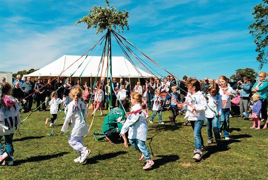 Schoolgirls dance around the maypole at the spring fête in Dilwyn, Herefordshire.