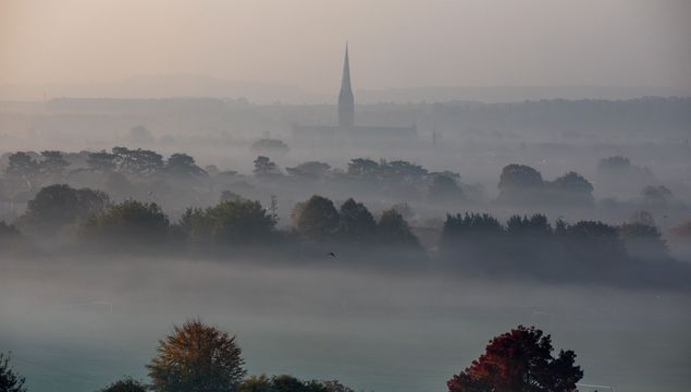 Mist surrounds Salisbury Cathedral as dawn breaks in Salisbury on October 10, 2018 in Wiltshire, England.