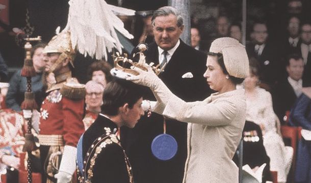 Queen Elizabeth II dubs Prince Charles, The Prince of Wales, in 1969.