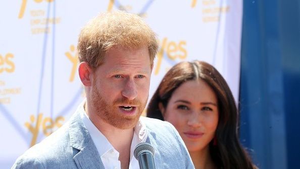 Meghan, Duchess of Sussex looks on as Prince Harry, Duke of Sussex speaks during a visit a township to learn about Youth Employment Services on October 02, 2019 in Johannesburg, South Africa