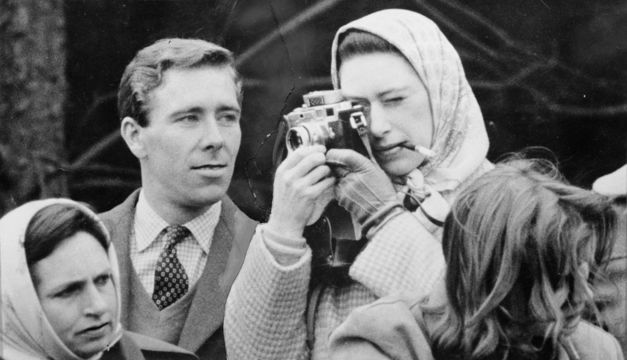 Professional photographer Antony Armstrong-Jones, the Earl of Snowdon, watches critically as his fiancee Princess Margaret (1930 - 2002) takes a snap at the Badminton Horse Trials