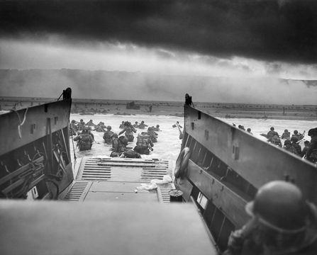 Digitally restored vintage World War II photo of American troops wading ashore on Omaha Beach during the D-Day invasion on June 6, 1944