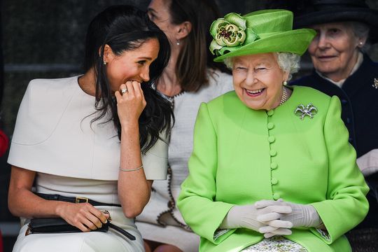 Queen Elizabeth II sitts and laughs with Meghan, Duchess of Sussex during a ceremony to open the new Mersey Gateway Bridge on June 14, 2018 in the town of Widnes in Halton, Cheshire, England