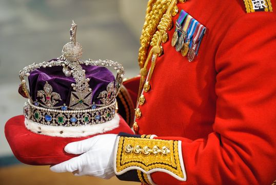 The Imperial State Crown is carried through the Norman Porch of the Palace of Westminster during the State Opening of Parliament on May 09, 2012 in London, England
