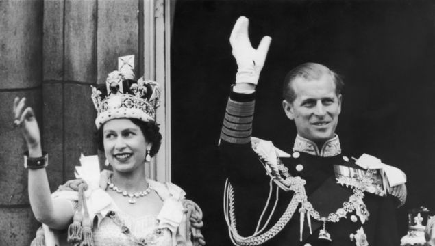 2nd June 1953: Queen Elizabeth II and the Duke of Edinburgh wave at the crowds from the balcony at Buckingham Palace.