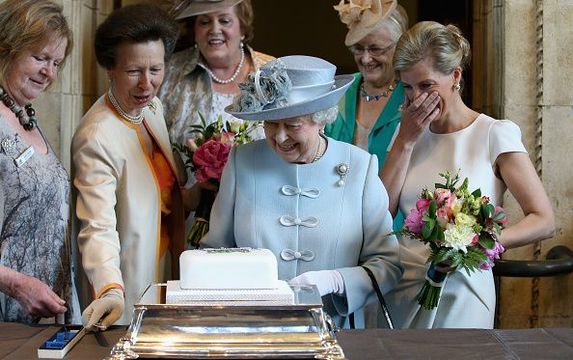 Sophie, Countess of Wessex and Princess Anne, Princess Royal look on as Queen Elizabeth II cuts a Women\'s Institute Celebrating 100 Years cake at the Centenary Annual Meeting of The National Federation Of Women\'s Institute at the Royal Albert Hall on June 4, 2015 in London, England. (Photo by Chris Jackson-WPA Pool/Getty Images)