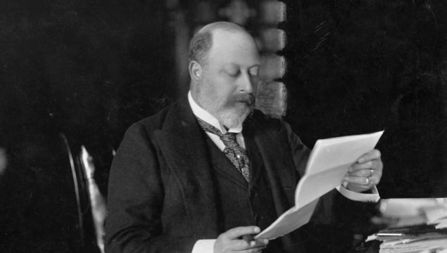 King Edward VII, (1841 - 1910), who ascended the British throne in 1901, as Prince of Wales, reading at Sandringham, Norfolk