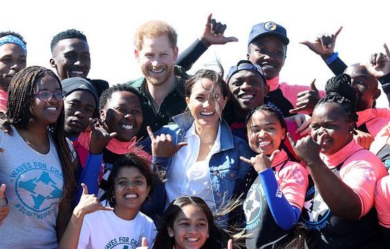Prince Harry, Duke of Sussex and Meghan, Duchess of Sussex poses with surf mentors as they visit Waves for Change, an NGO, at Monwabisi Beach on September 24, 2019 in Cape Town, South Africa. Waves for Change supports local surf mentors to provide mental health services to vulnerable young people living in under resourced communities. (Photo by Chris Jackson - Pool/Getty Images)