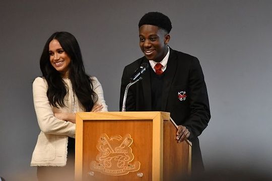 Meghan, Duchess of Sussex smiles as the student Aker Okoye speaks during a special school assembly at the Robert Clack Upper School in Dagenham ahead of International Women’s Day (IWD) held on Sunday 8th March, on March 6, 2020 in London, England. (Photo by Ben Stansall-WPA Pool/Getty Images)