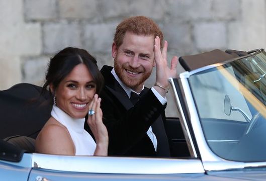 Duchess of Sussex and Prince Harry, Duke of Sussex wave as they leave Windsor Castle after their wedding to attend an evening reception at Frogmore House, hosted by the Prince of Wales on May 19, 2018 in Windsor, England. (Photo by Steve Parsons - WPA Pool/Getty Images)