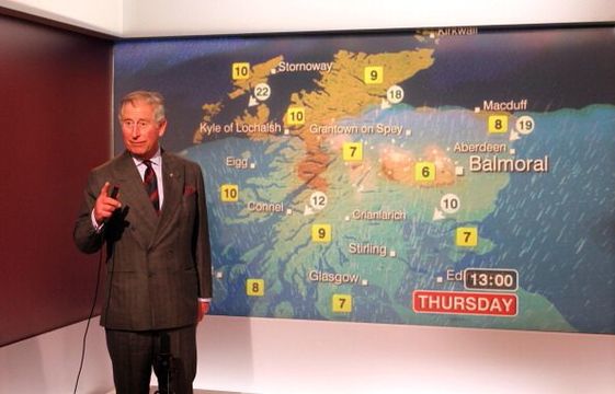 King Charles reads the weather in the Six O\'Clock studio during a tour of the BBC Scotland Headquarters where they met staff to celebrate sixty years of BBC Scotland Television on May 10, 2012 in Glasgow, Scotland. (Photo by Andrew Milligan - WPA Pool/Getty Images)