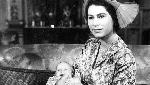 Queen Elizabeth II holding baby Princess Anne.