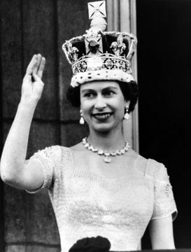 Queen Elizabeth II waves to the crowds from the balcony of Buckingham Palace, on June 2, 1953.