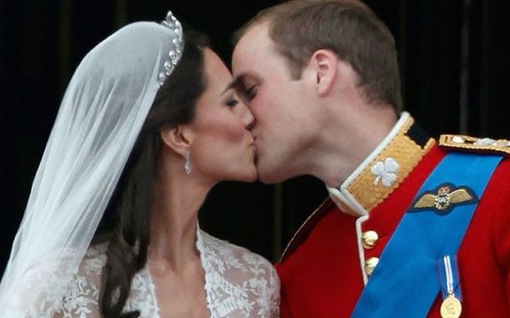 Catherine, Princess of Wales and Prince William, Prince of Wales kiss on the balcony at Buckingham Palace on April 29, 2011 in London, England. 
