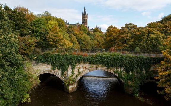 University of Glasgow behind lush trees, Glasgow, Scotland