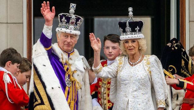 King Charles and Queen Consort Camilla pose greet the public from Buckingham Palace\'s balcony following their coronation.