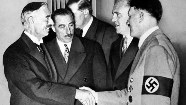 September 30, 1938: British Prime Minister Neville Chamberlain shakes the hand of Adolf Hitler in Munich. 