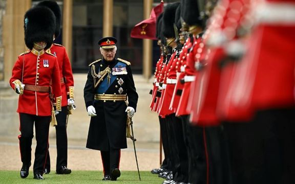 Britain\'s King Charles III (C) reviews the Irish Guards during a ceremony where he presents New Colours to No 9 and No 12 Company The Irish Guards at Windsor Castle on June 10, 2024 in Windsor.