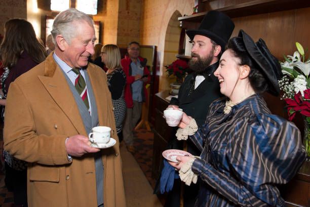 King Charles drinks tea with actors wearing period dress during a visit to Castell Coch to learn about the castle's history, refurbishment and programme of community activities on December 8, 2017 in Cardiff, Wales. (Photo by Matthew Horwood/Getty Images)