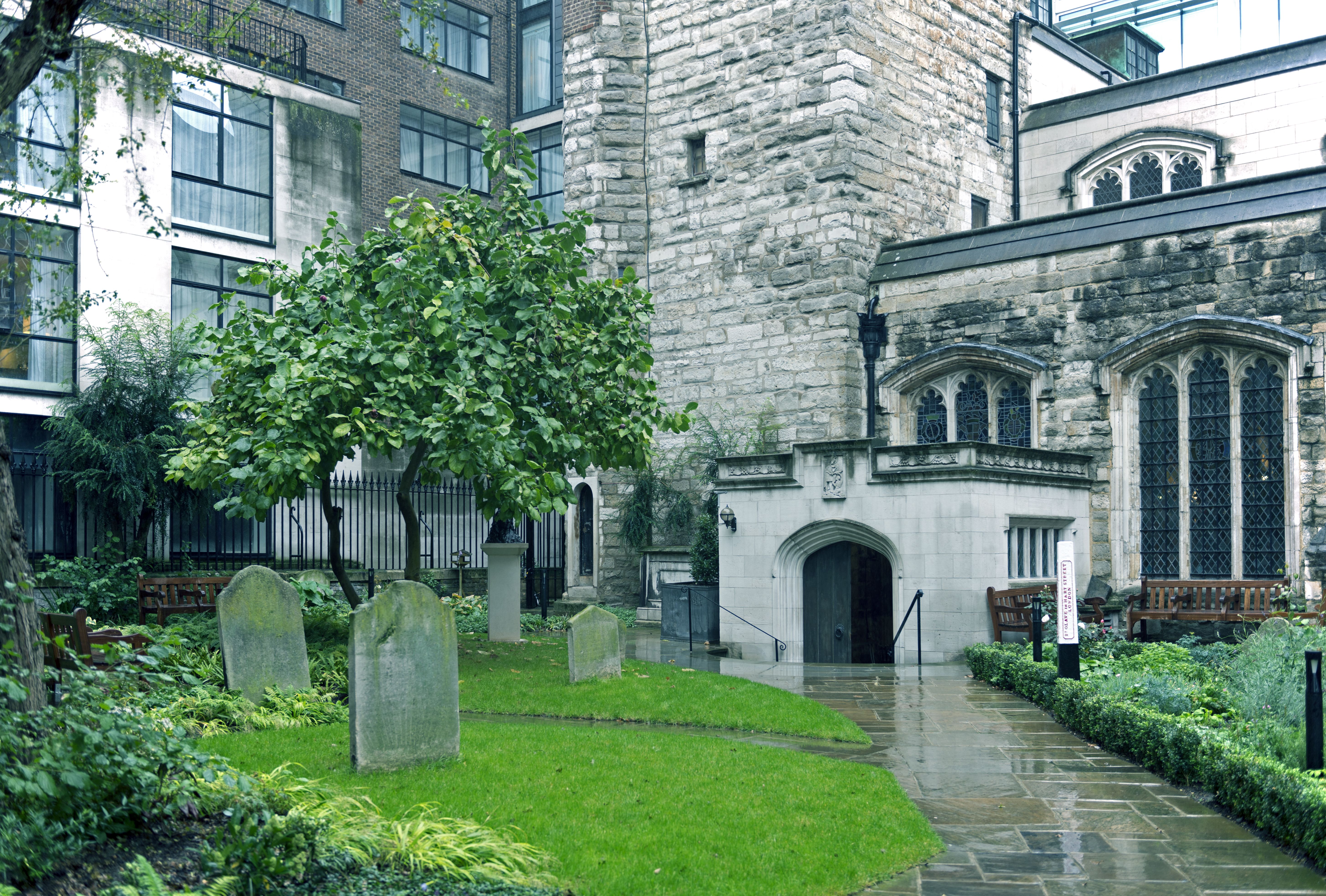 Medieval church of St Olave on Hart Street in The City surrounded by modern structures in London England