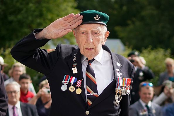 D-Day veteran Reg Charles, aged 96, the last surviving member of the heroic glider assault on Pegasus Bridge salutes during a memorial ceremony at the Pegasus Bridge Museum