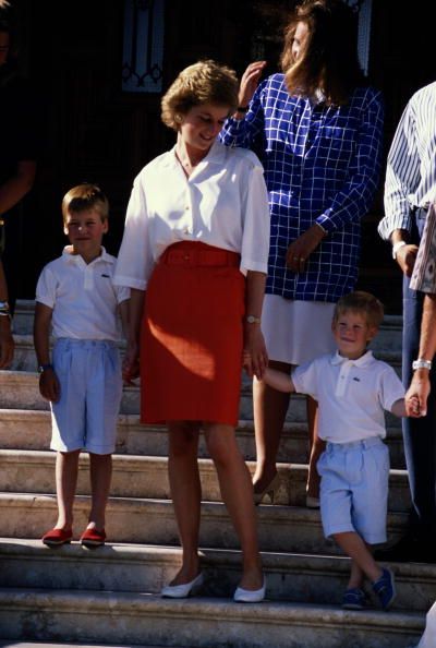 Princess Diana (1961 - 1997) with her sons, Prince William (left) and Prince Harry at a photocall on the steps of the Marivent Palace during their summer holiday in Majorca, July 1988. (Photo by Jayne Fincher/Princess Diana Archive/Getty Images)