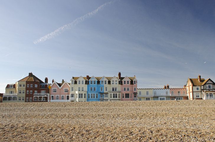 The colourful row of seafront houses in the popular coastal town of Aldeburgh, Suffolk, UK on a sunny spring day.