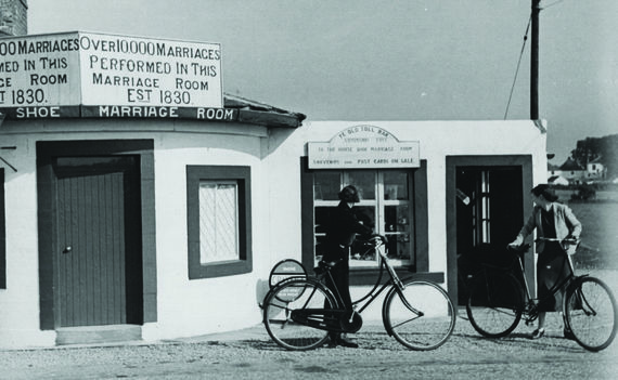 Two girls looking at the first marriage-house at Gretna Greene, circa 1950.