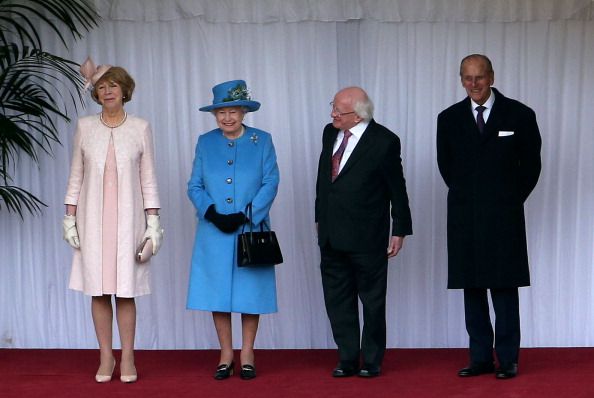 Sabina Coyne, Queen Elizabeth II, the President of Ireland Michael D Higgins and Prince Philip, Duke of Edinburgh inspect the guard at Windsor Castle on April 8, 2014 in Windsor, England. This is the first official visit by the head of state of the Irish Republic to the United Kingdom. (Photo by Steve Parsons - WPA Pool/Getty Images)