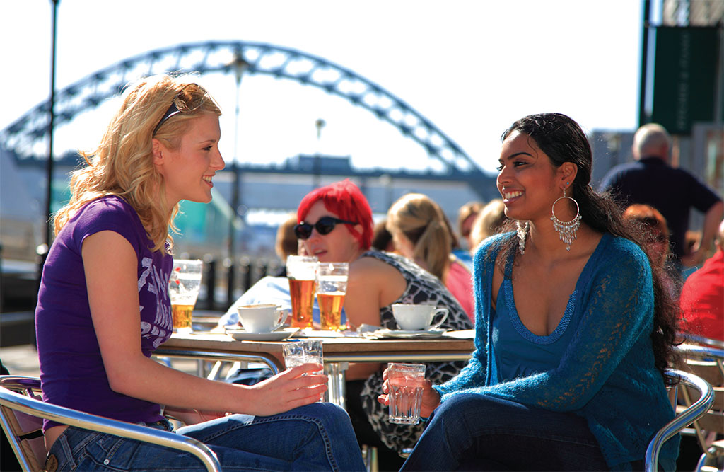 Against the backdrop of the Tyne Bridge, two friends share a laugh over drinks outside the Pitcher and Piano on Quayside. Against the backdrop of the Tyne Bridge, two friends share a laugh over drinks outside the Pitcher and Piano on Quayside.