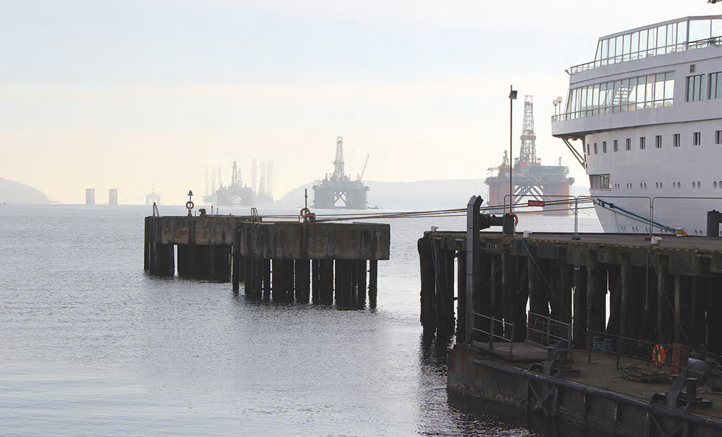 Boudicca lies at dock in the Cromarty Firth, with a row of oil rigs brought in from the North Sea until the price of oil rises. Via: Dana Huntley